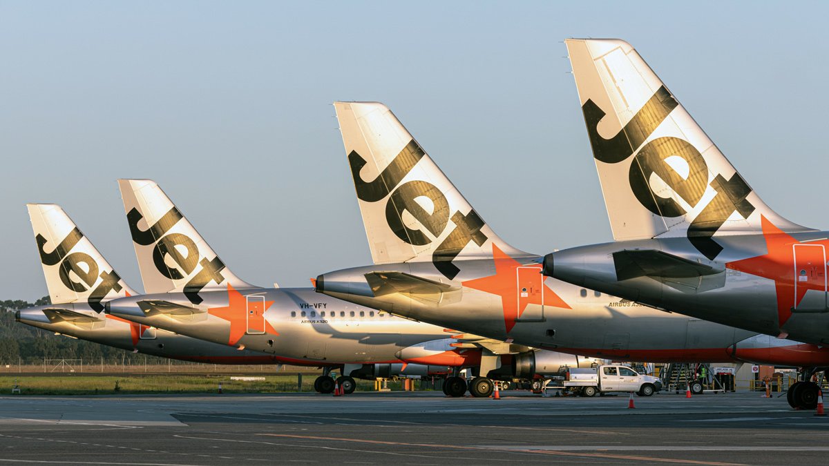 a group of airplanes parked on a runway