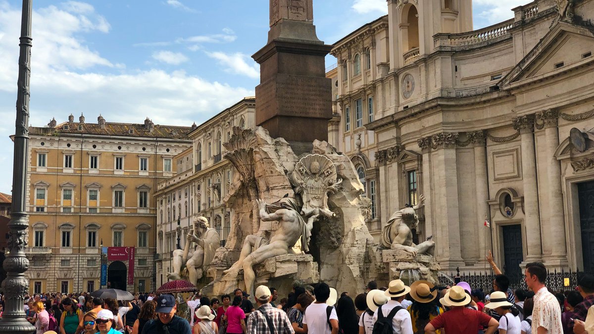 a group of people around a statue