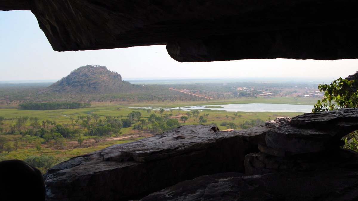 a view of a valley from a cave