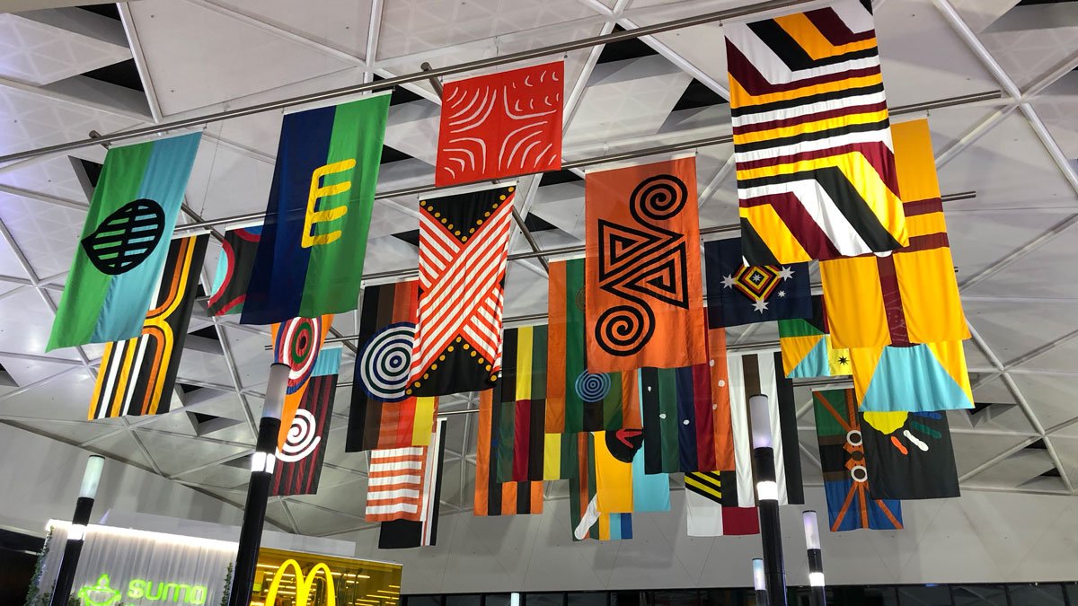 a group of colorful flags from a ceiling