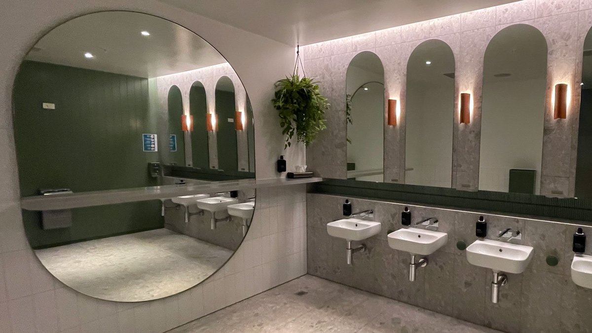 a bathroom with mirrors and sinks