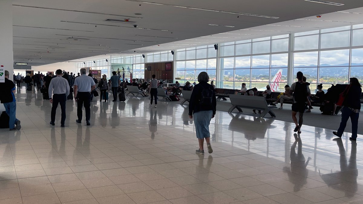 people walking in a large airport terminal