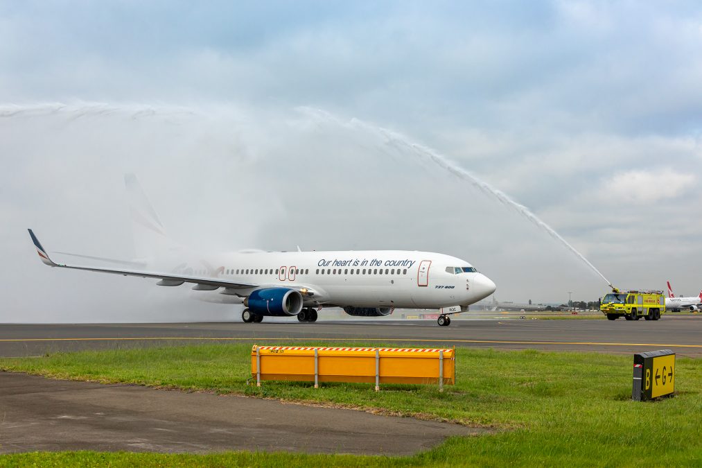 a jet plane spraying water on runway