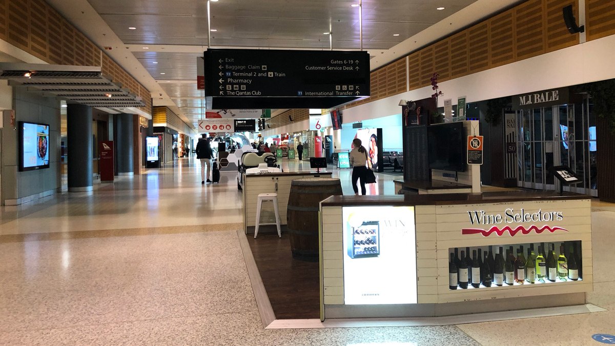 a large airport with people walking and people walking