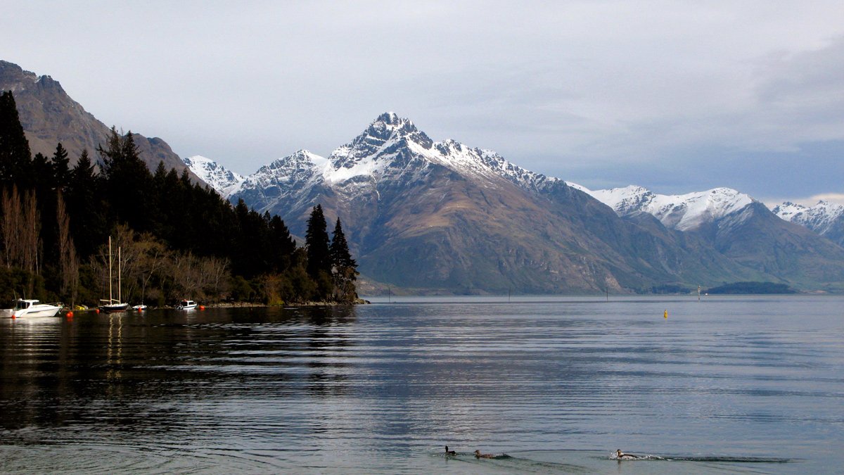 a lake with mountains in the background