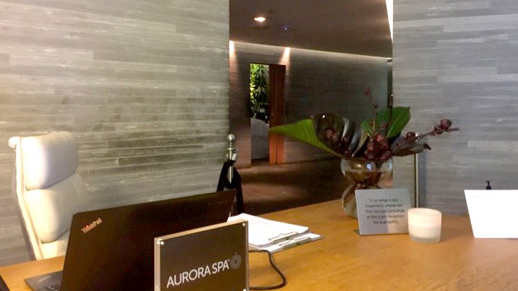 a desk with a sign and a plant on it