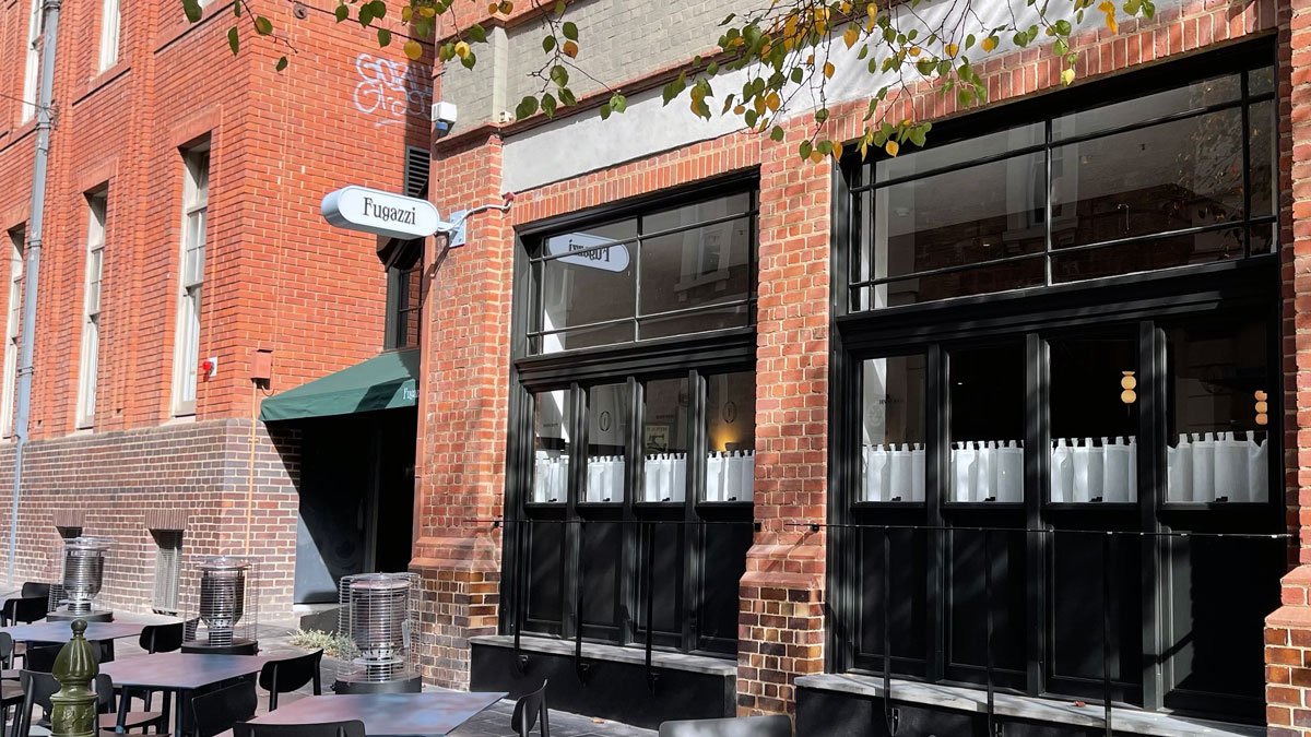 a brick building with windows and a sign