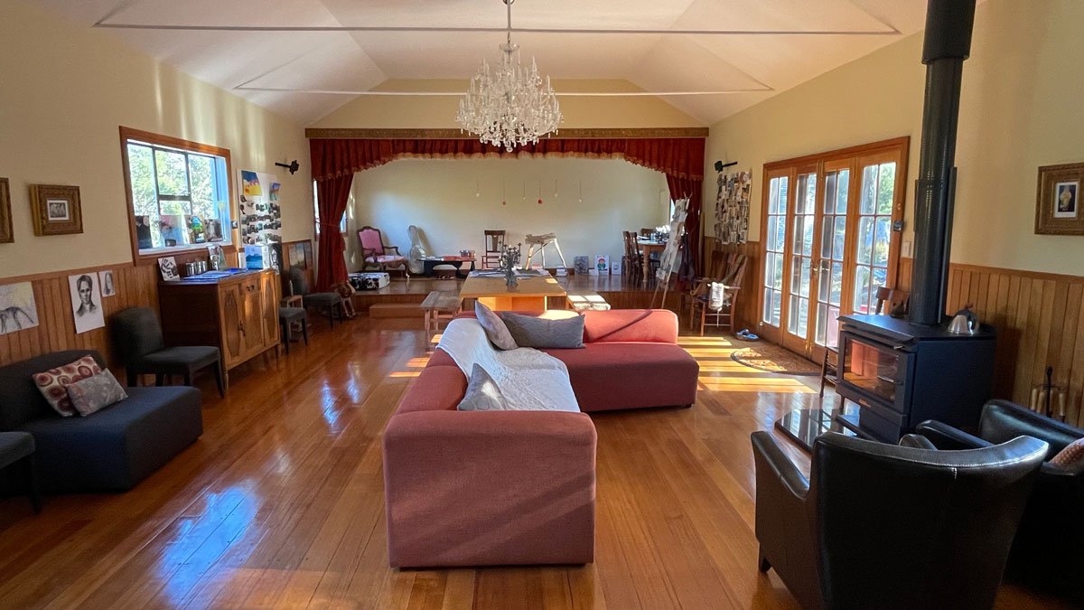 a living room with a couch and a chandelier