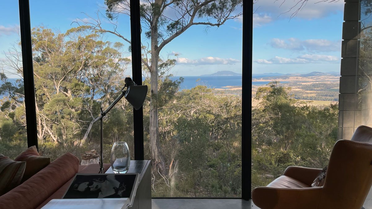 a room with a view of the ocean and trees