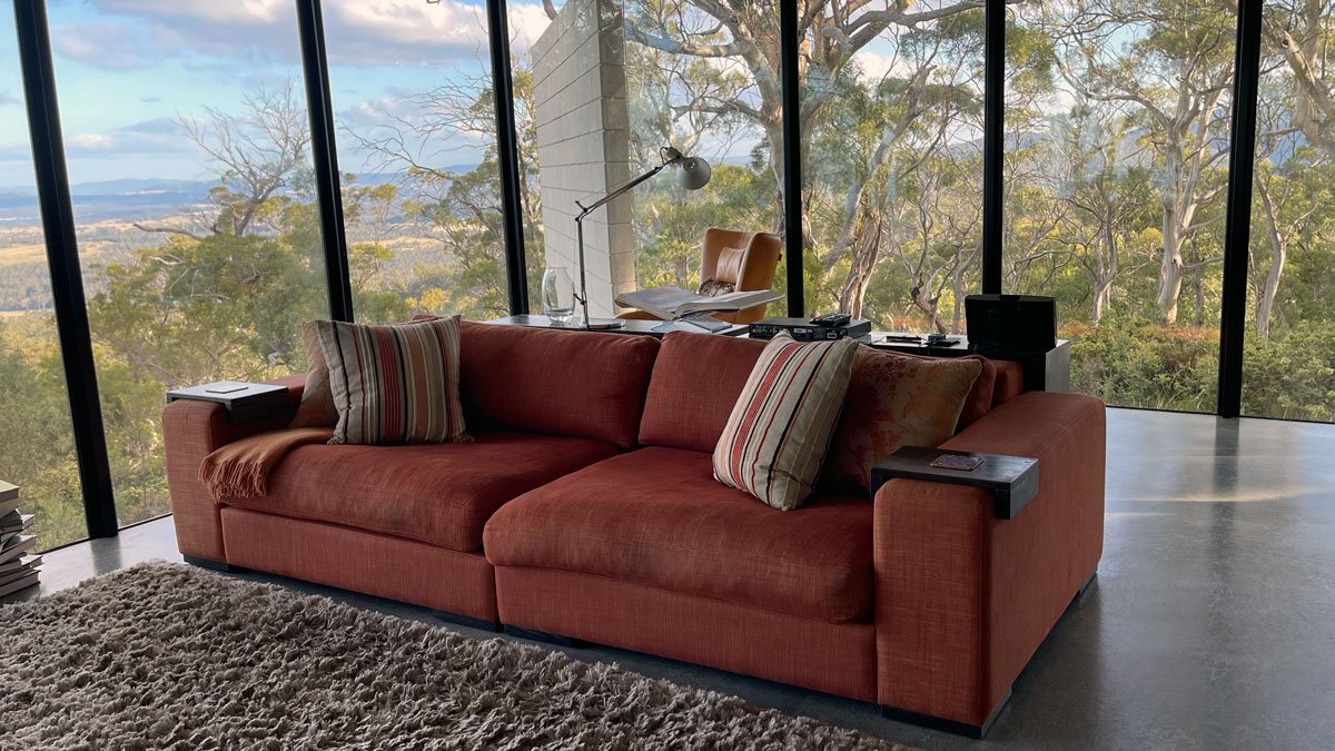 a couch in a room with large windows