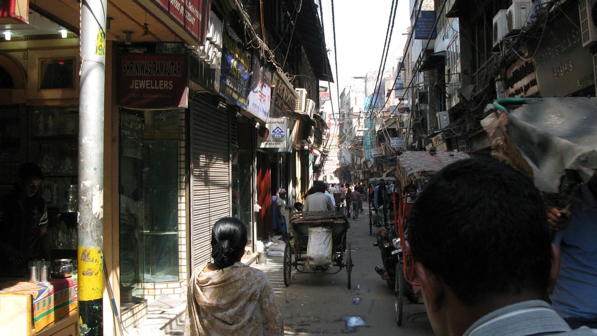 a street with people and a horse carriage