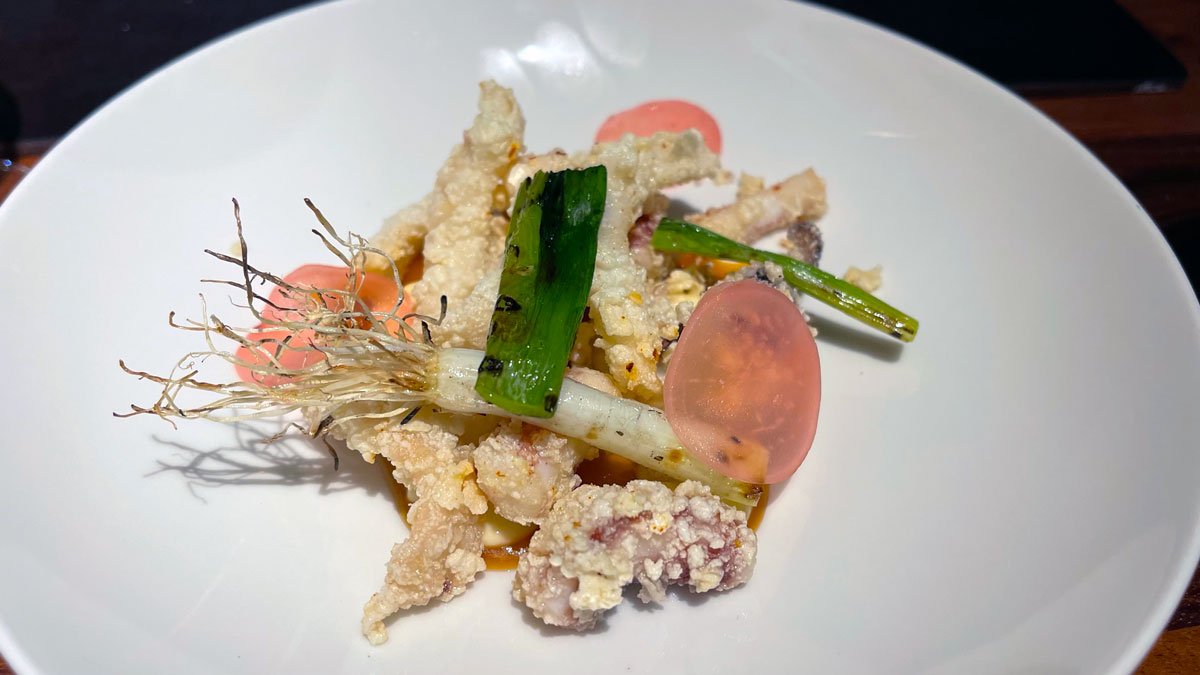 a plate of food on a black surface