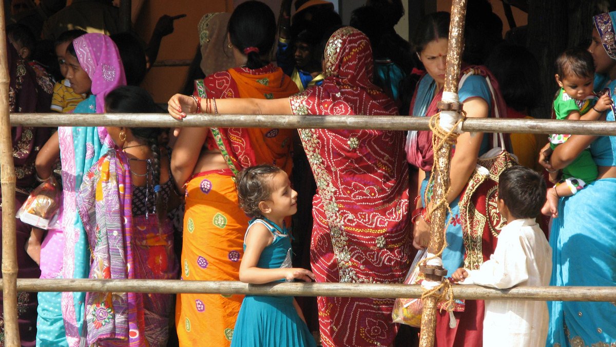 a group of women and a child standing next to each other