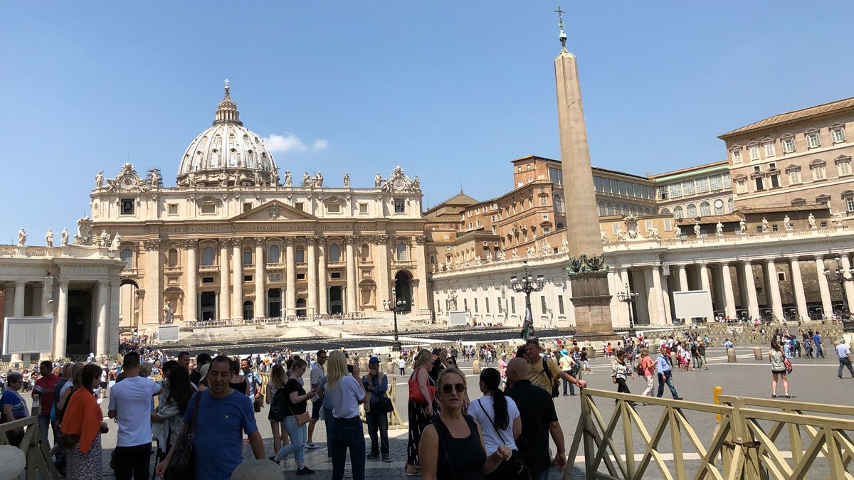 a group of people in front of a large building