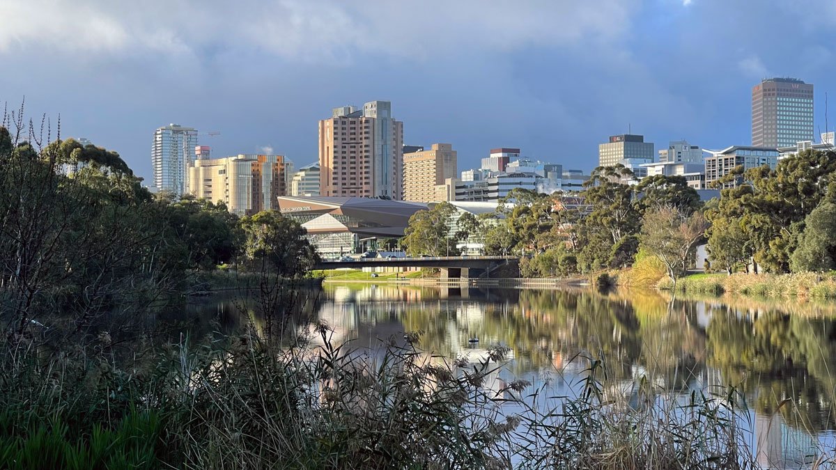 a body of water with a city in the background