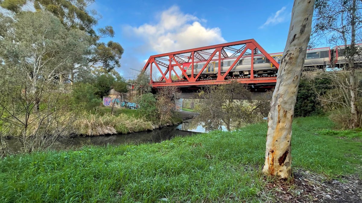 a train on a bridge over a river