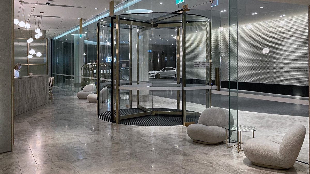 a glass room with a round table and chairs