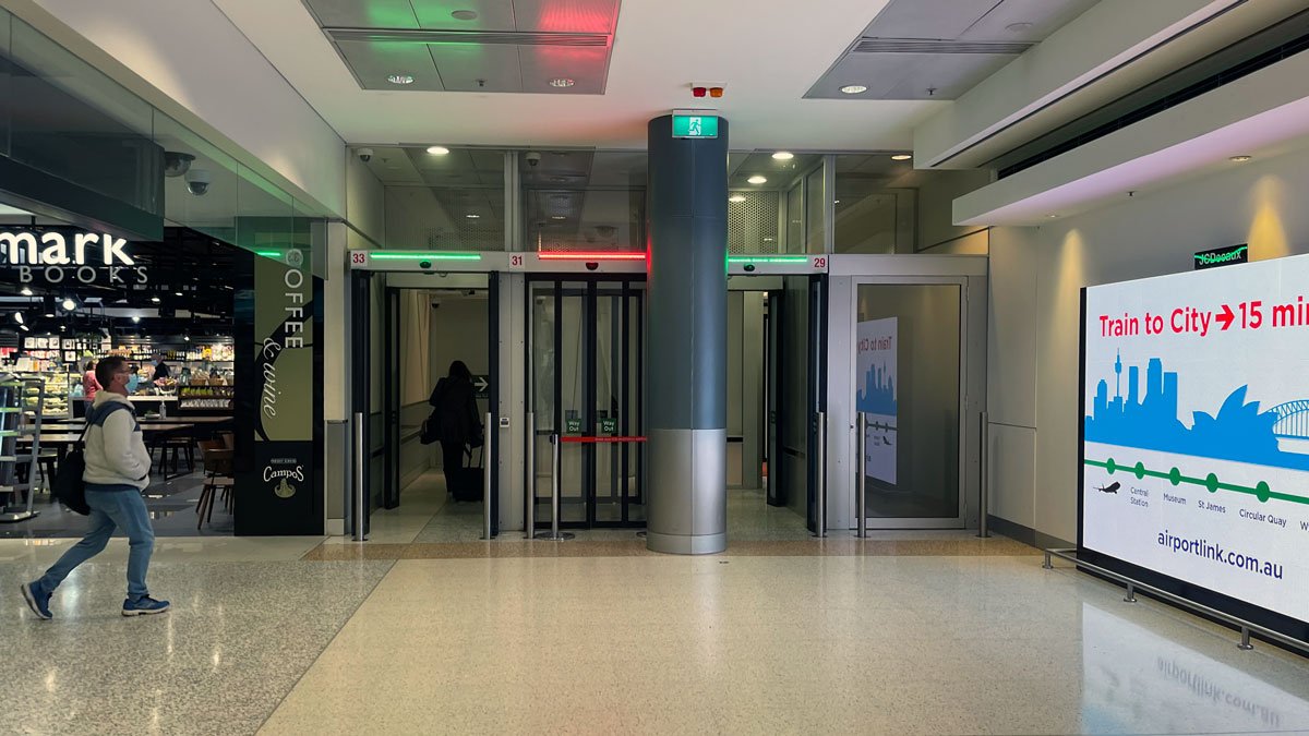 a building with glass doors and a person walking