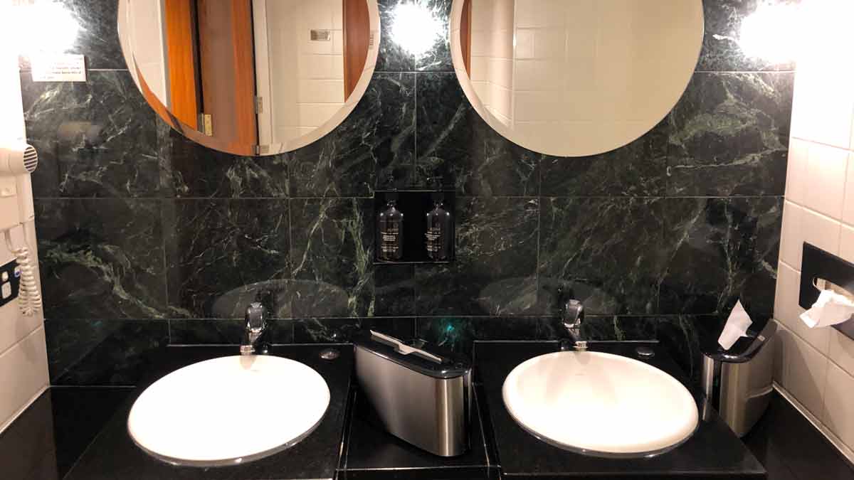 a bathroom with two sinks and a mirror