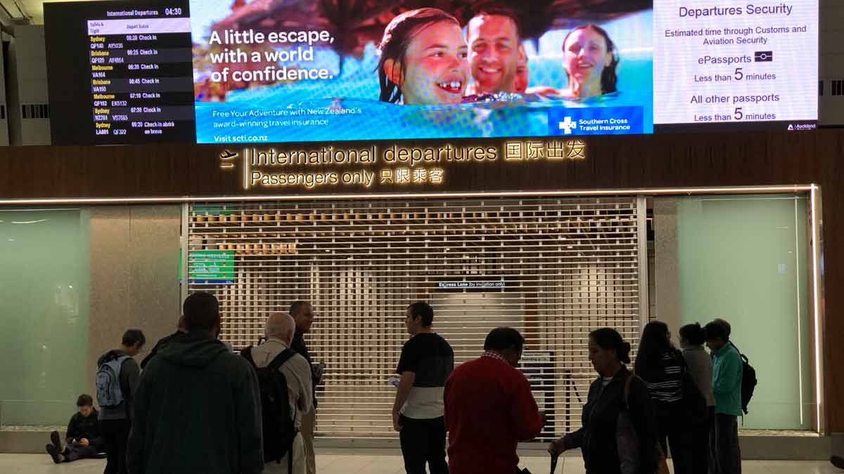 a group of people standing in front of a sign