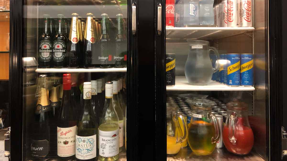 a refrigerator with bottles of alcohol