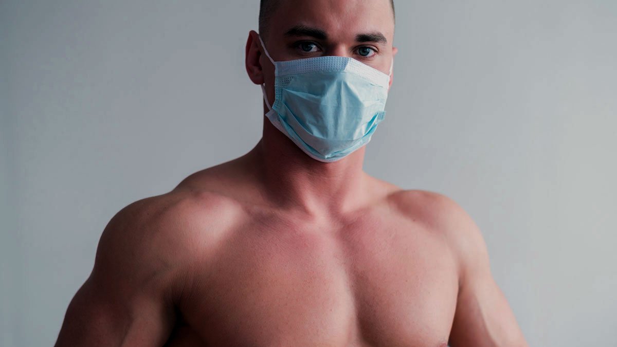 a shirtless man wearing a mask