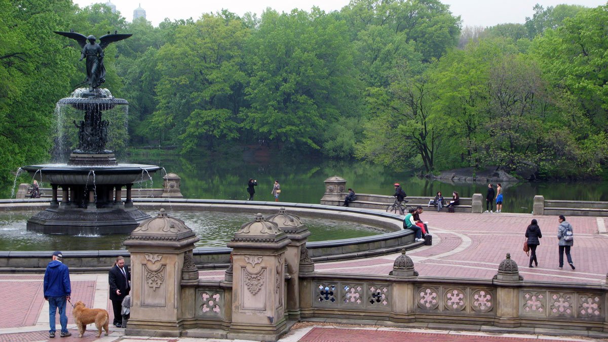 a group of people sitting on a bench in a park