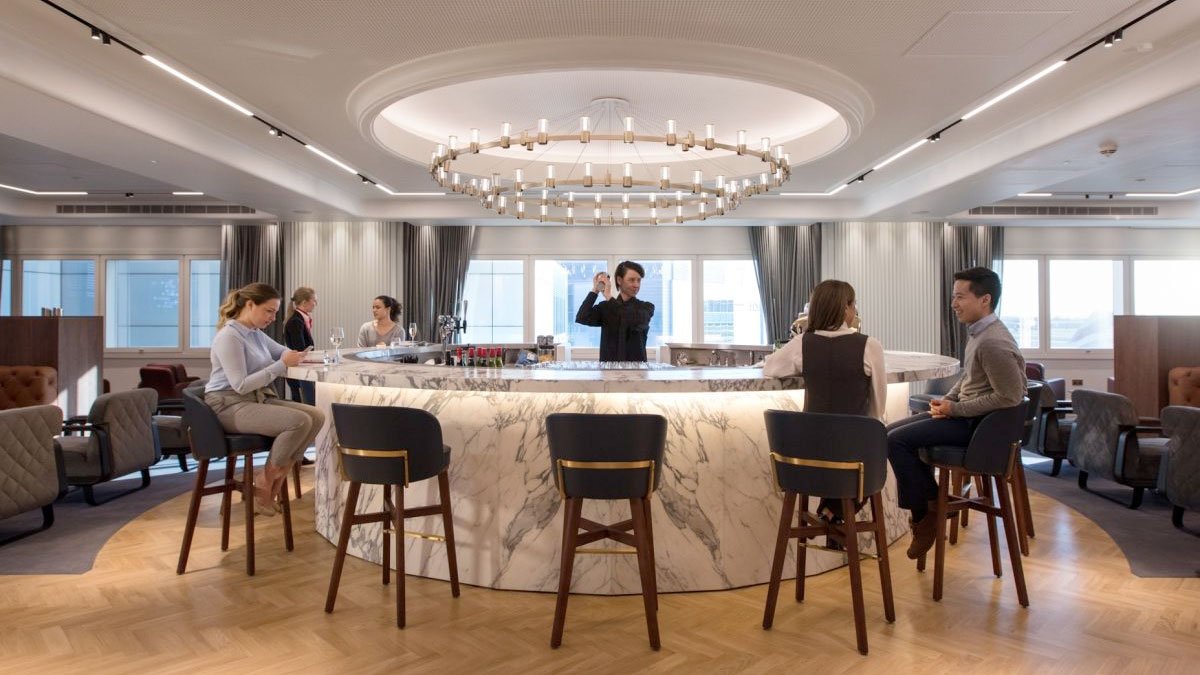 a group of people sitting around a round bar