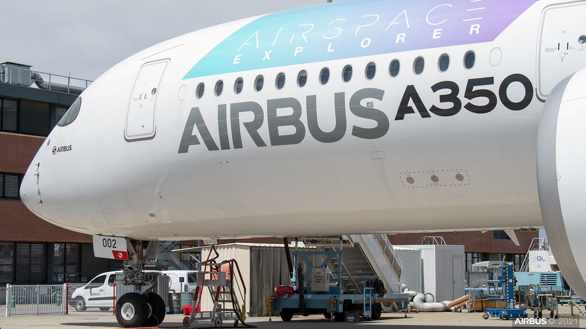a large white airplane with blue and white text