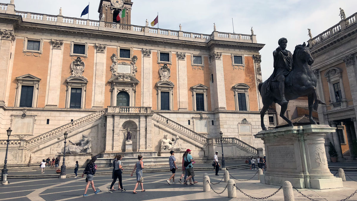a group of people walking in front of a building