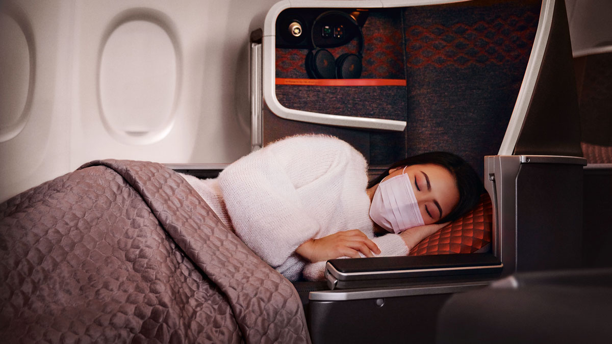 a woman sleeping in a plane