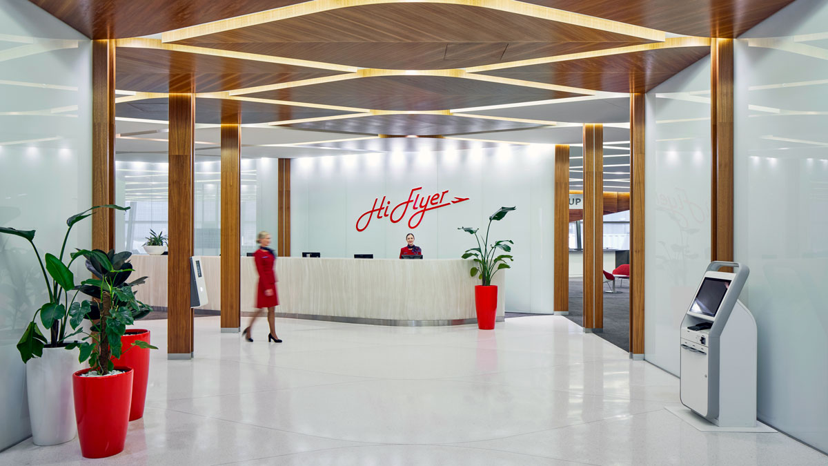 a woman walking past a reception desk