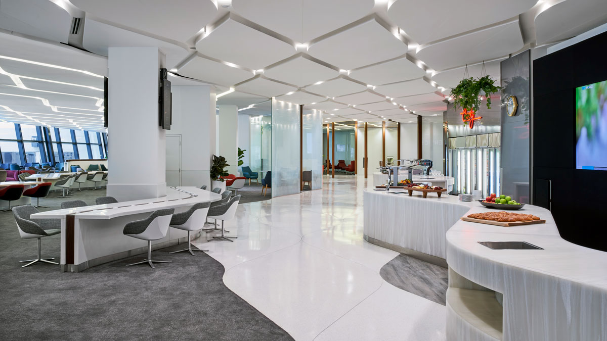 a white room with a white counter and chairs