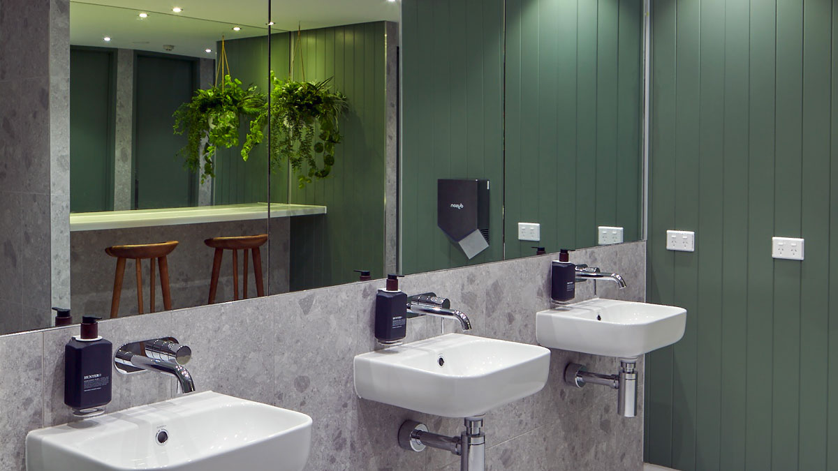 a bathroom with sinks and mirrors