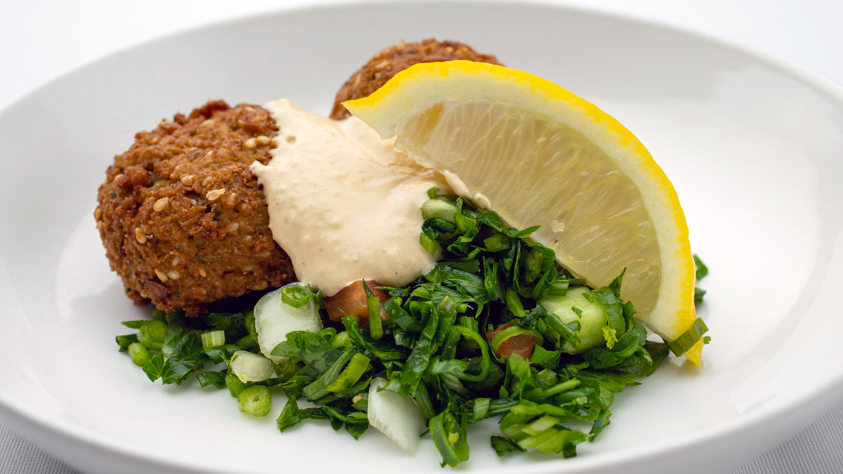 a plate of food with a lemon wedge