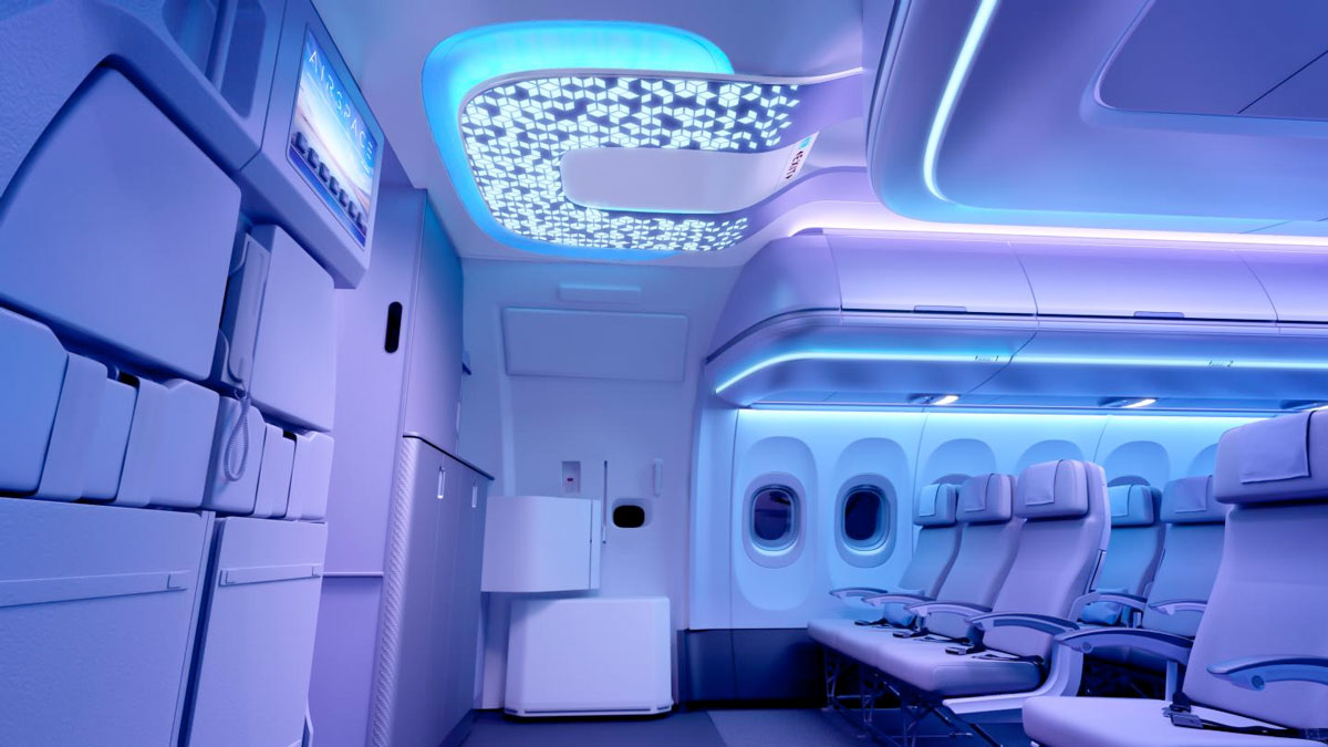 a interior of an airplane with seats and a tv