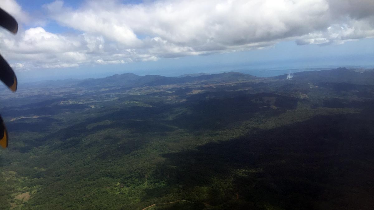 a view of a landscape with mountains and clouds