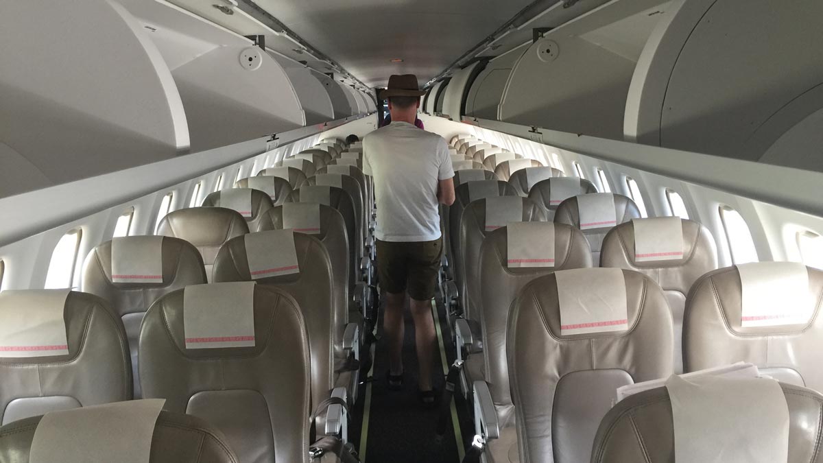 a man walking in an airplane