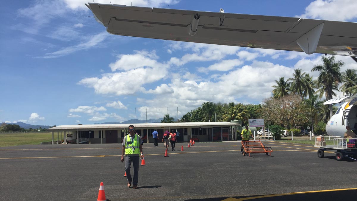 a man walking on a tarmac