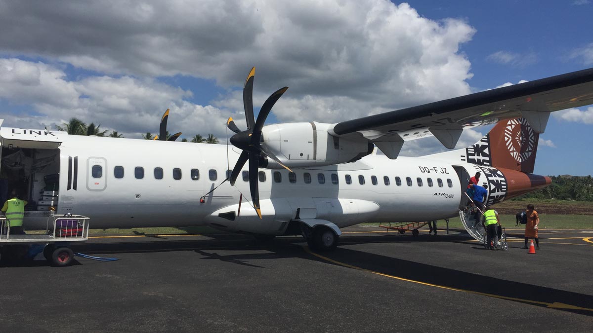 a white airplane with black propellers