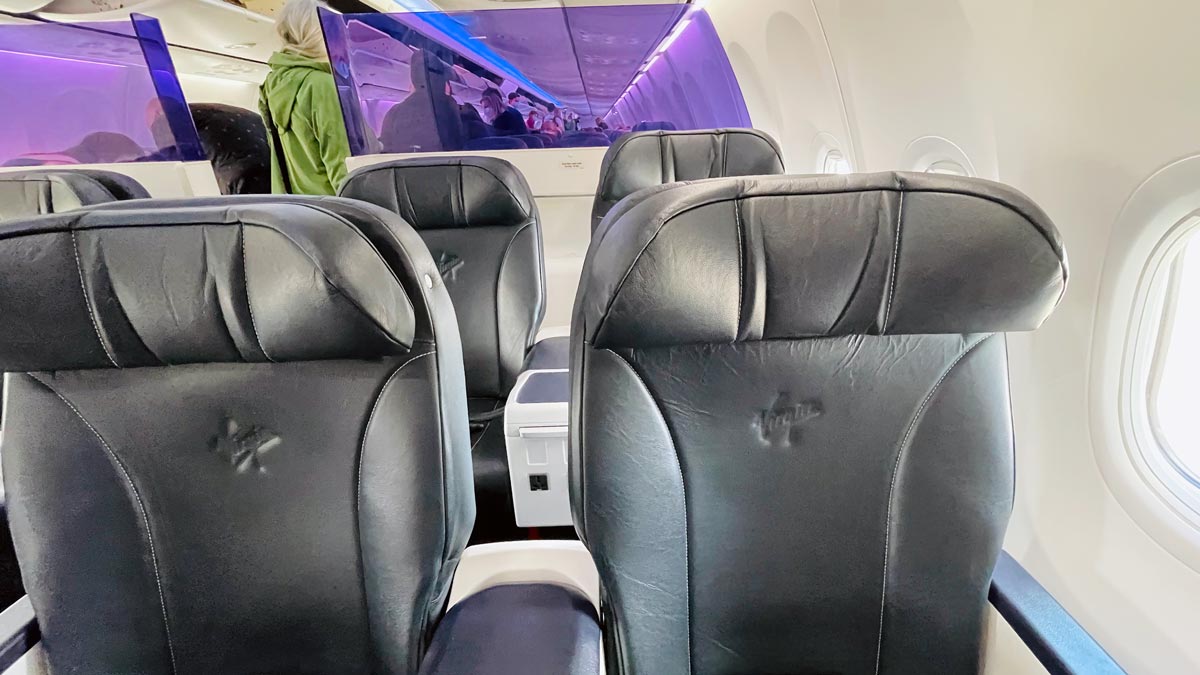 the inside of an airplane with black seats