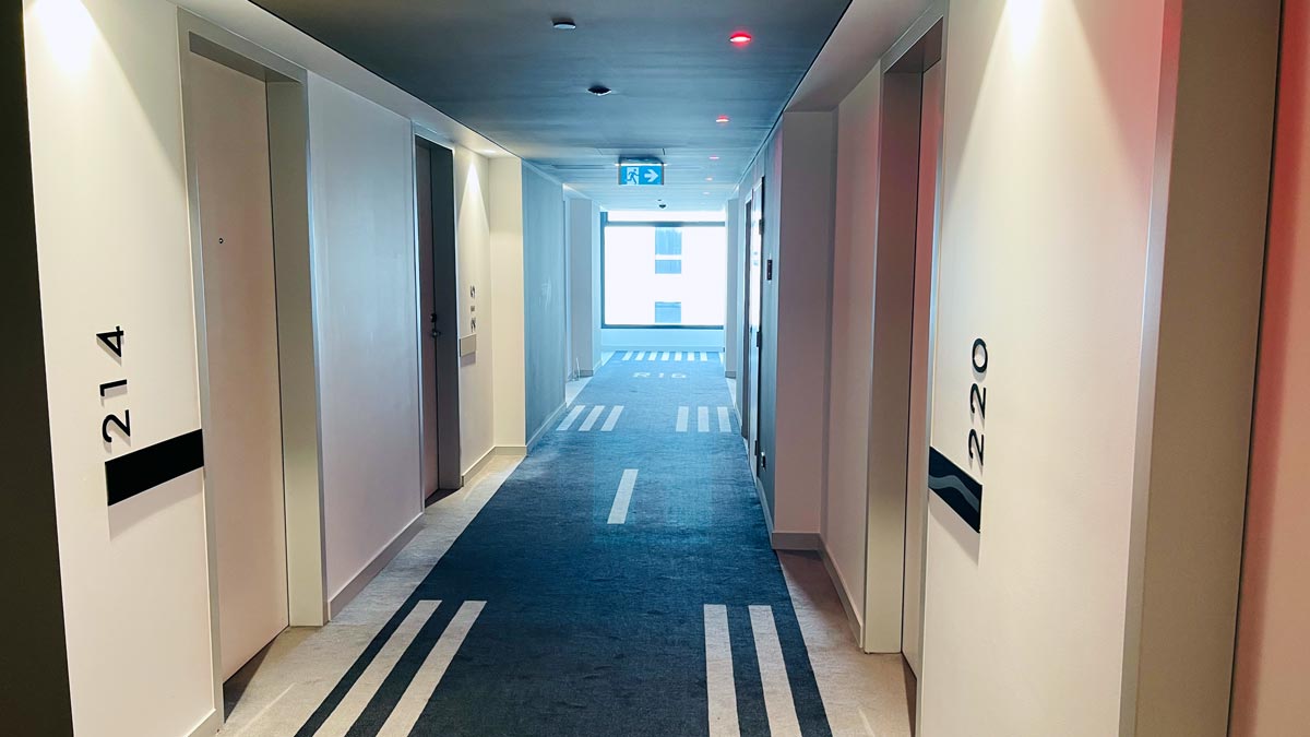 a hallway with doors and signs