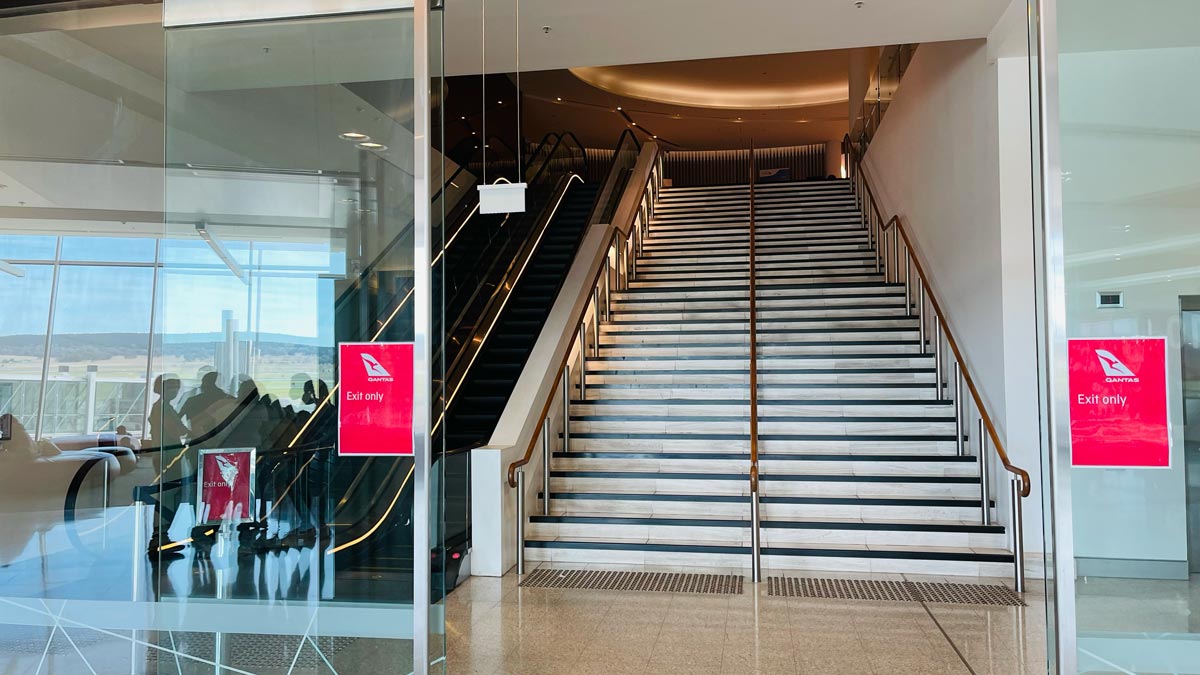 a staircase with a red sign