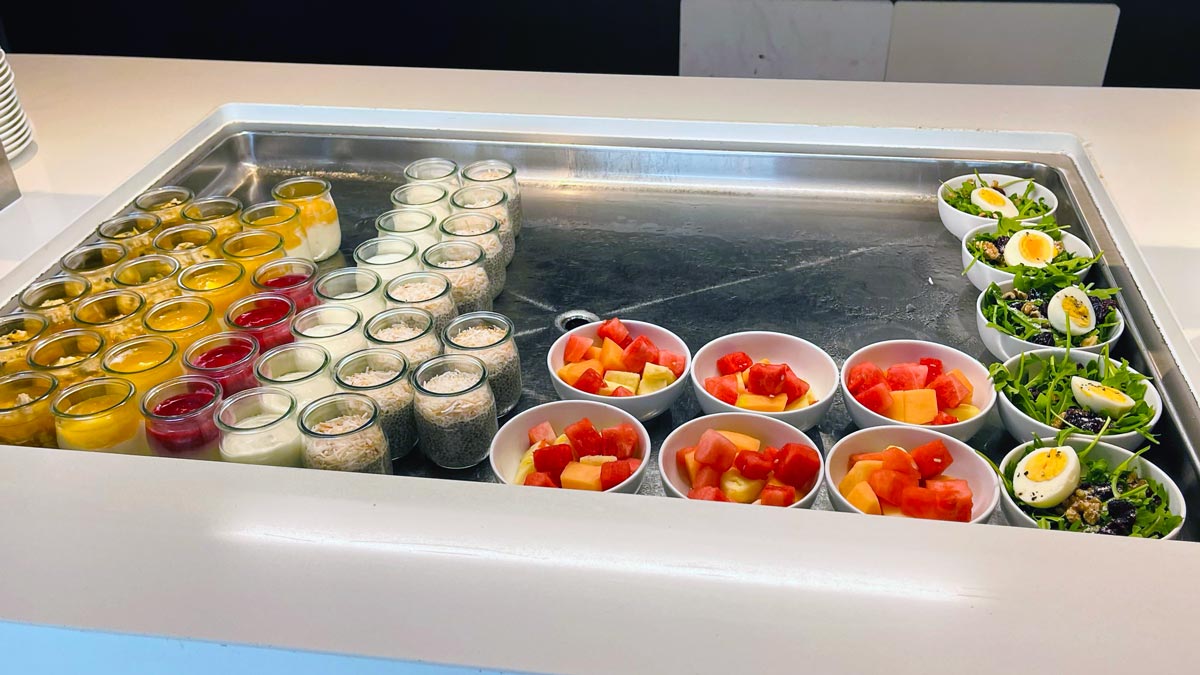 a group of bowls of fruit in a row