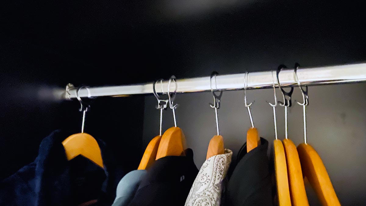 a group of clothes on hooks