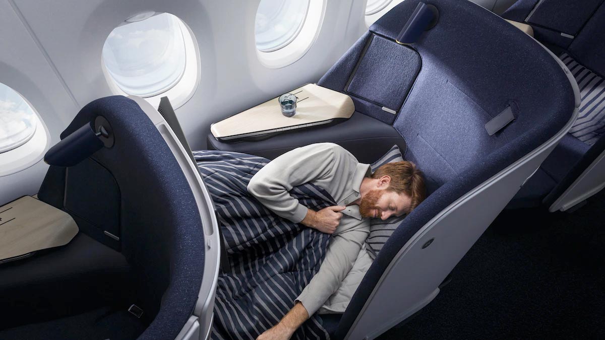 a man sleeping in a plane