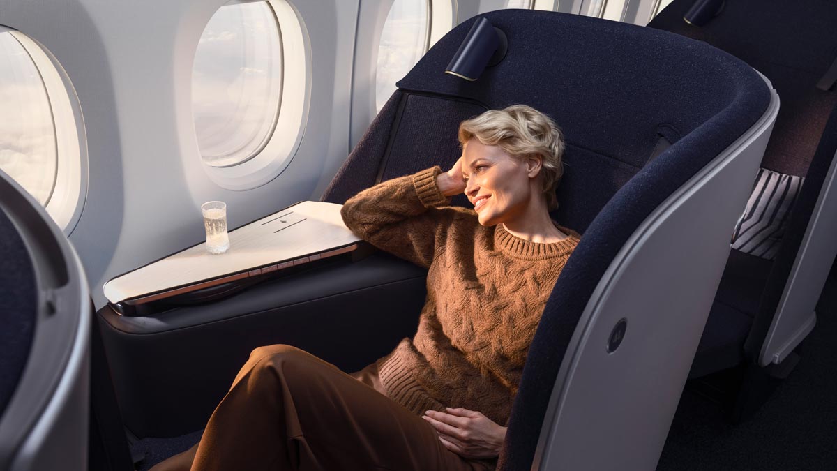 a woman sitting in a chair with her head in her hand