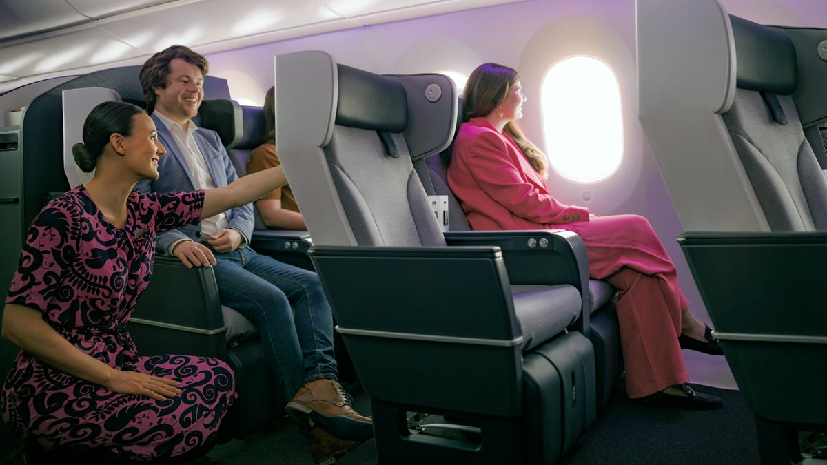 a man and woman sitting in chairs on an airplane