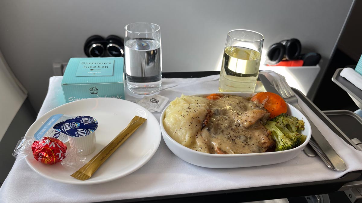 a plate of food and a glass of water on a table