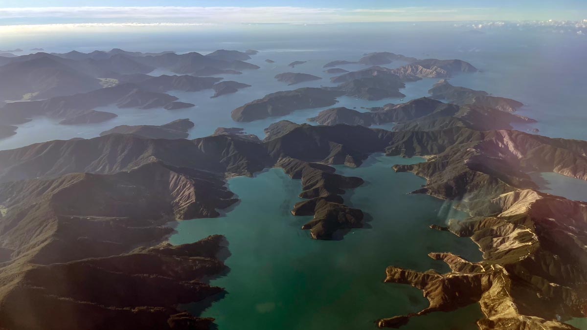an aerial view of a body of water and mountains